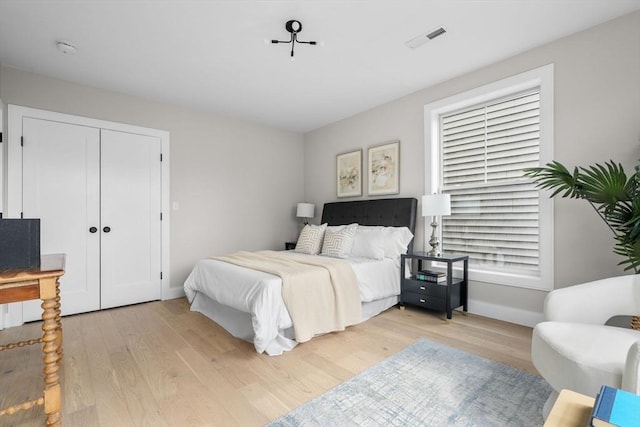 220 Bowen St Unit 2, Boston, MA 02127 - bedroom featuring light wood-style floors, baseboards, and a closet