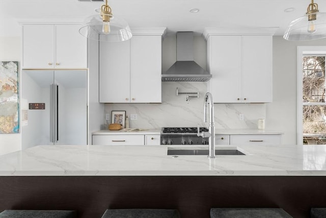 220 Bowen St Unit 2, Boston, MA 02127 - kitchen with wall chimney range hood, a sink, light stone countertops, and backsplash