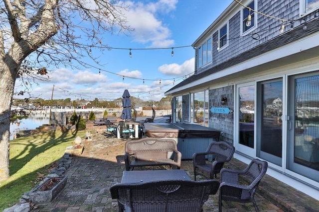 view of patio / terrace featuring fence and a hot tub