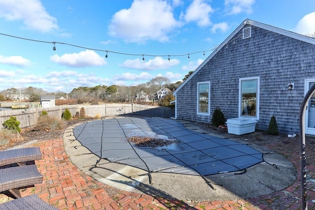 view of swimming pool featuring a fenced in pool, a patio, and a fenced backyard