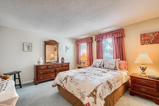 bedroom with light carpet and a textured ceiling