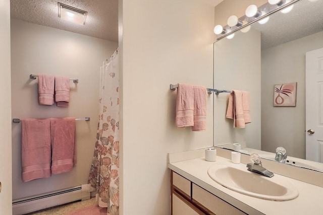 bathroom featuring vanity, a textured ceiling, and baseboard heating