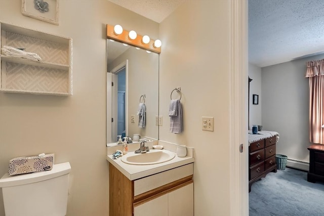 bathroom with vanity, a baseboard heating unit, a textured ceiling, and toilet