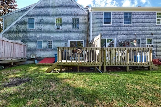 back of property featuring a yard and a deck