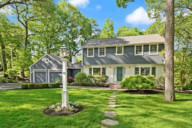 49 James Rd, Reading, MA 01867 - colonial home featuring driveway, a front lawn, and a garage