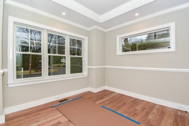 workout room with recessed lighting, crown molding, baseboards, and wood finished floors