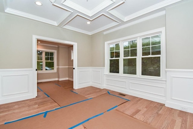 unfurnished room featuring coffered ceiling, wainscoting, wood finished floors, crown molding, and recessed lighting