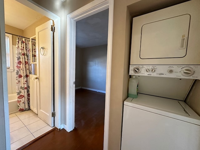 washroom featuring stacked washer and dryer and light wood-type flooring