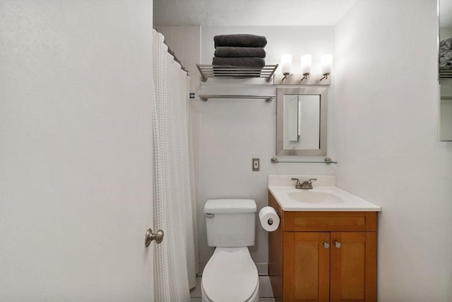 full bathroom featuring vanity and toilet
