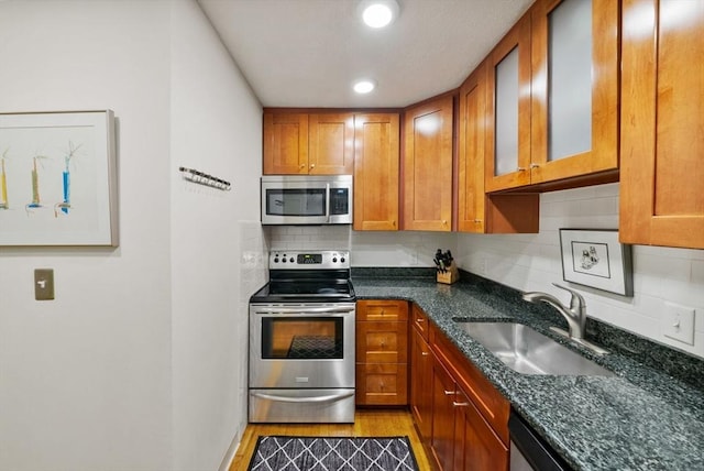 kitchen featuring a sink, brown cabinetry, and stainless steel appliances