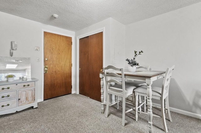 35 Prospect St Unit 313, Woburn, MA 01801 - carpeted dining area with a textured ceiling and baseboards