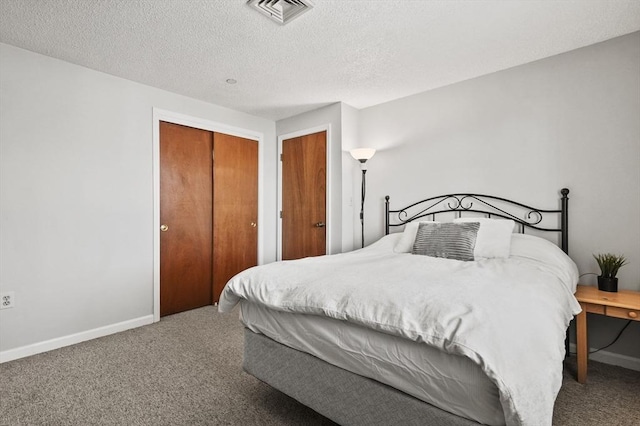 35 Prospect St Unit 313, Woburn, MA 01801 - carpeted bedroom featuring baseboards, a textured ceiling, and a closet