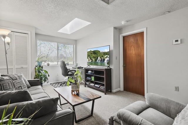 35 Prospect St Unit 313, Woburn, MA 01801 - carpeted living area with a skylight, a textured ceiling, and baseboards