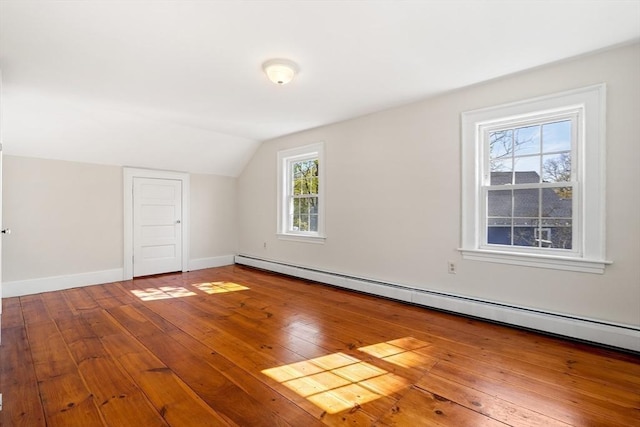bonus room featuring baseboards, vaulted ceiling, wood-type flooring, and a baseboard radiator