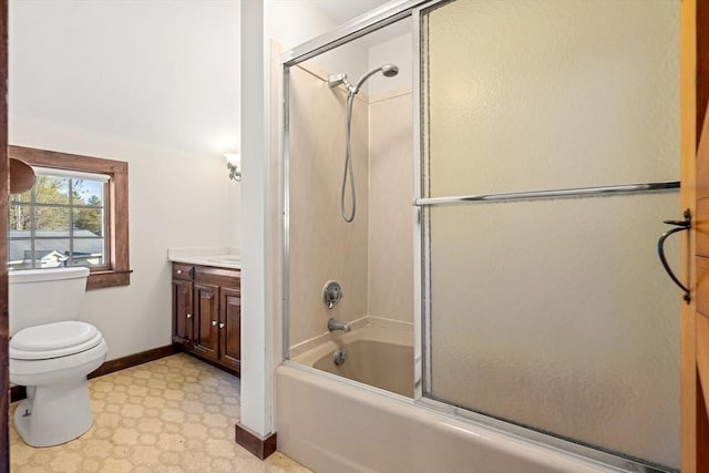 full bathroom featuring baseboards, enclosed tub / shower combo, toilet, tile patterned floors, and vanity