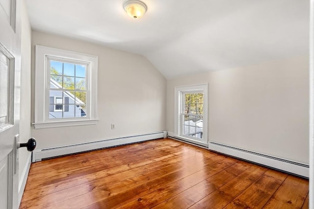 bonus room with vaulted ceiling, a healthy amount of sunlight, and a baseboard radiator