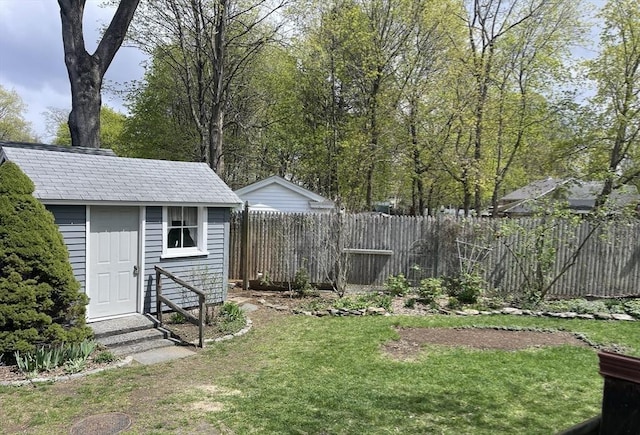 view of yard with fence, entry steps, and an outdoor structure
