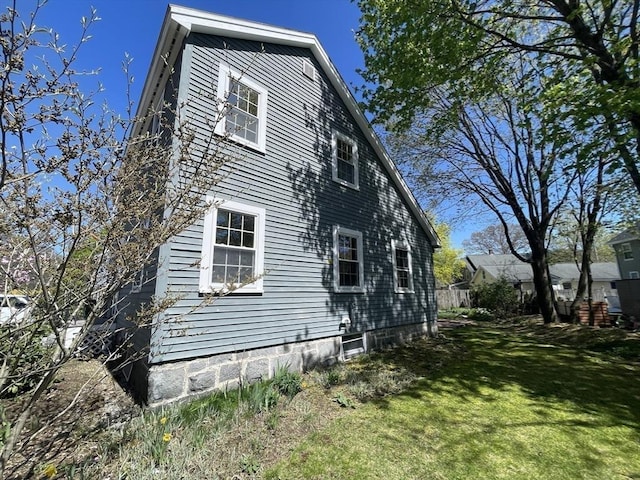 view of property exterior with a lawn