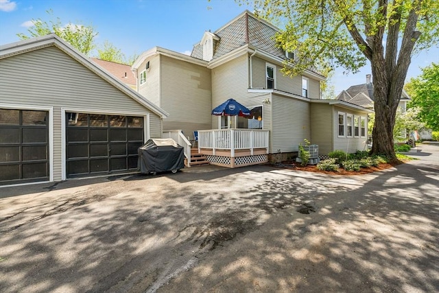 50 Walnut St, Northampton, MA 01060 - view of front of property with a deck, driveway, a garage, and central AC