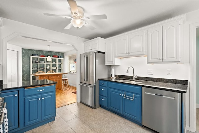 50 Walnut St, Northampton, MA 01060 - kitchen featuring stainless steel appliances, a sink, blue cabinets, dark countertops, and white cabinets