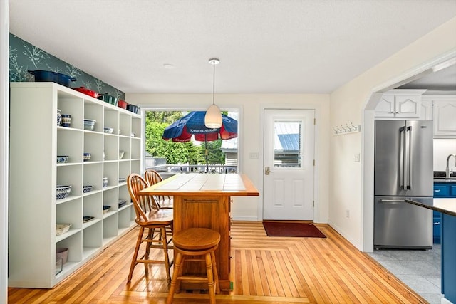 50 Walnut St, Northampton, MA 01060 - dining room with light wood finished floors, baseboards, and arched walkways
