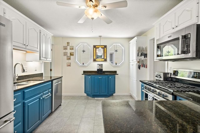 50 Walnut St, Northampton, MA 01060 - kitchen with stainless steel appliances, blue cabinetry, a sink, and white cabinets