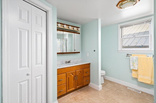 50 Walnut St, Northampton, MA 01060 - bathroom with toilet, tile patterned flooring, vanity, baseboards, and a closet