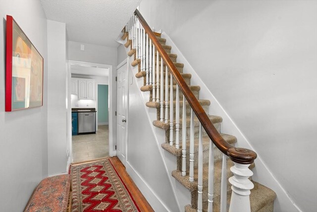 50 Walnut St, Northampton, MA 01060 - stairway with a textured ceiling, baseboards, and wood finished floors