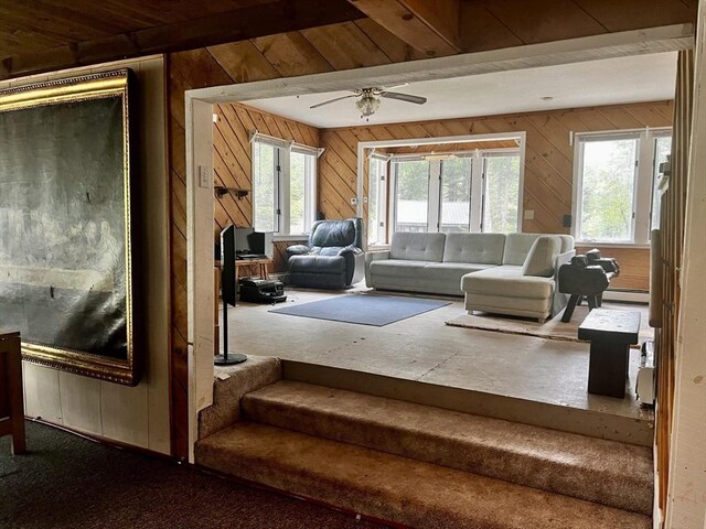 40 Papoose Lake Dr, Heath, MA 01346 - living area featuring wooden walls, carpet flooring, ceiling fan, and a baseboard heating unit