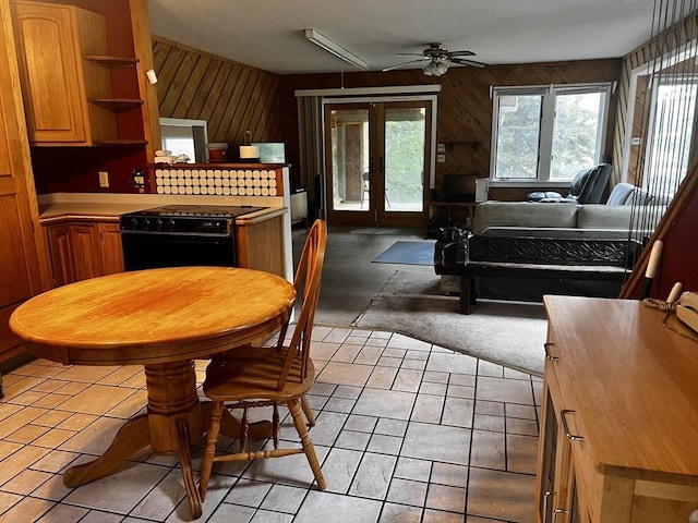 40 Papoose Lake Dr, Heath, MA 01346 - kitchen with black range, french doors, a ceiling fan, open shelves, and wood walls