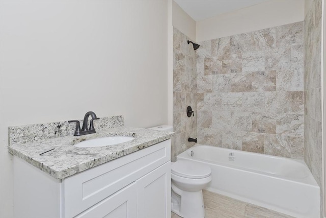 full bathroom featuring toilet, vanity, and tiled shower / bath combo