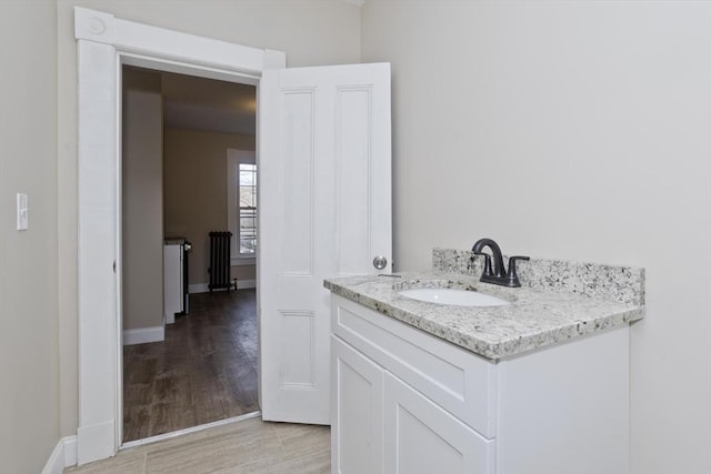 bathroom with vanity and hardwood / wood-style flooring