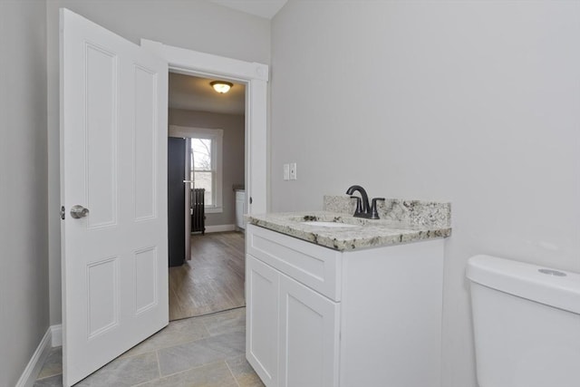 bathroom featuring toilet and vanity