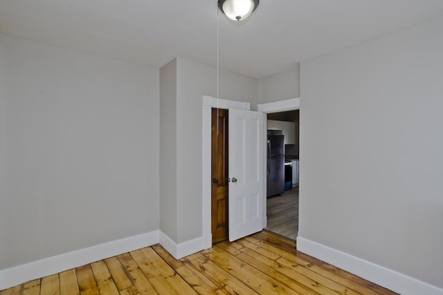 unfurnished room with light wood-type flooring