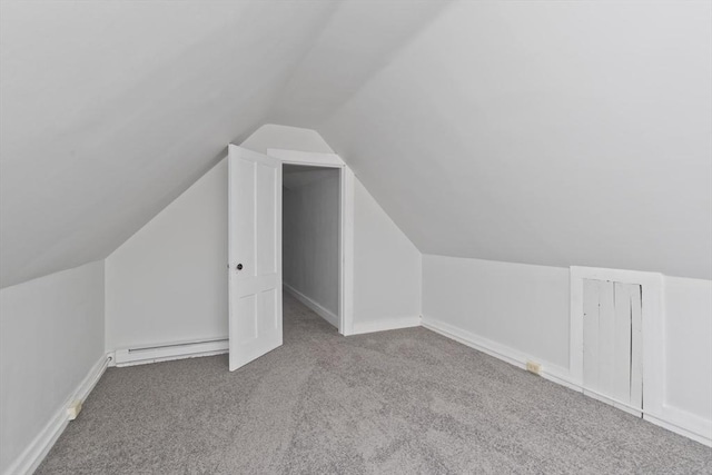 bonus room with lofted ceiling, light colored carpet, and baseboard heating