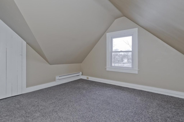 additional living space with vaulted ceiling, carpet flooring, and a baseboard radiator