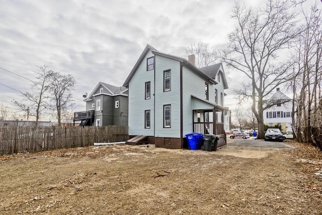 view of side of home featuring covered porch