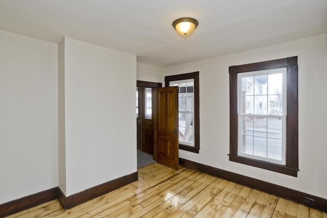 unfurnished room with light hardwood / wood-style flooring