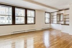 306 Columbus Ave Unit 2, Boston, MA 02116 - empty room featuring wood finished floors and a baseboard heating unit