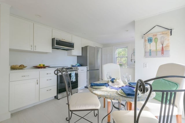 kitchen featuring appliances with stainless steel finishes and white cabinets