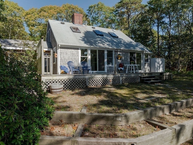 rear view of house featuring a deck