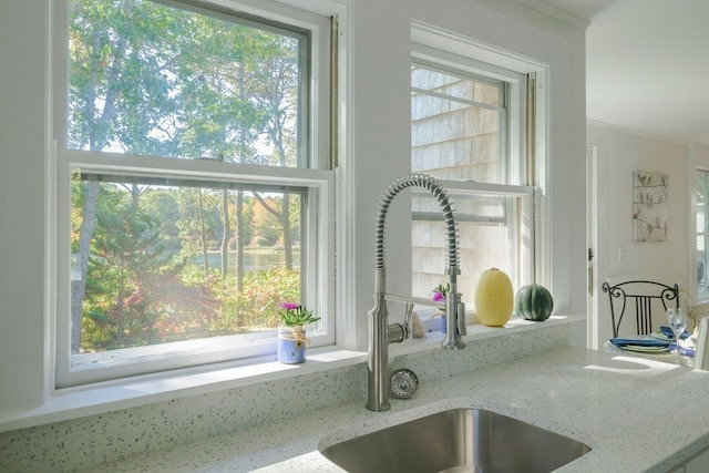 room details featuring sink and light stone counters