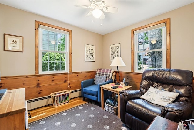 56 Conrad Rd, Melrose, MA 02176 - sitting room featuring healthy amount of natural light, ceiling fan, a baseboard heating unit, wainscoting, and wood walls