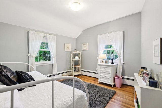 56 Conrad Rd, Melrose, MA 02176 - bedroom featuring multiple windows, lofted ceiling, light wood-type flooring, and a baseboard radiator
