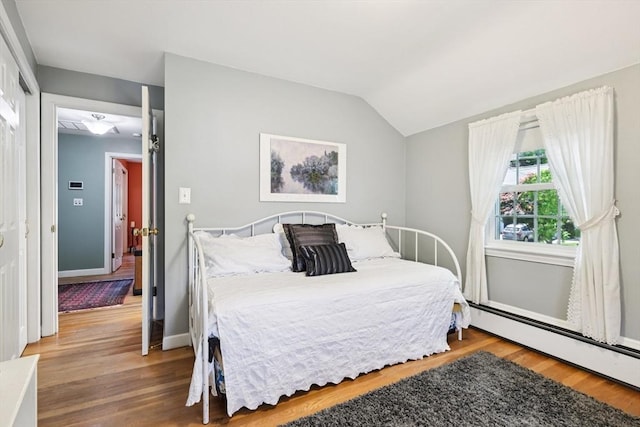 56 Conrad Rd, Melrose, MA 02176 - bedroom featuring wood finished floors, a baseboard heating unit, and lofted ceiling