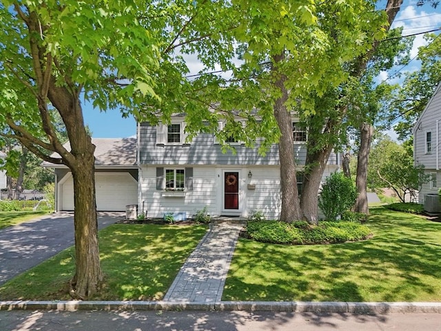 56 Conrad Rd, Melrose, MA 02176 - colonial house featuring asphalt driveway, an attached garage, and a front yard