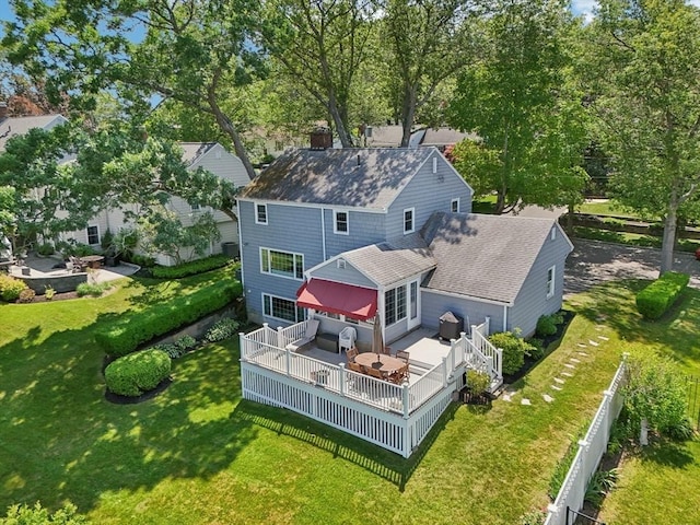56 Conrad Rd, Melrose, MA 02176 - rear view of house with roof with shingles, a wooden deck, and a fenced backyard