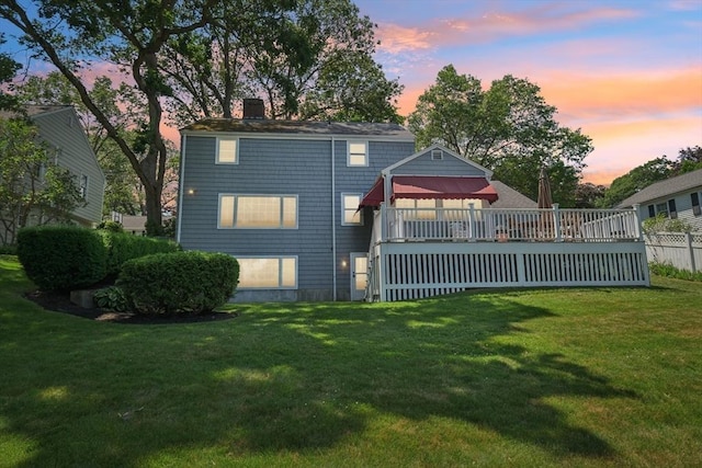56 Conrad Rd, Melrose, MA 02176 - back of property at dusk with a chimney and a deck