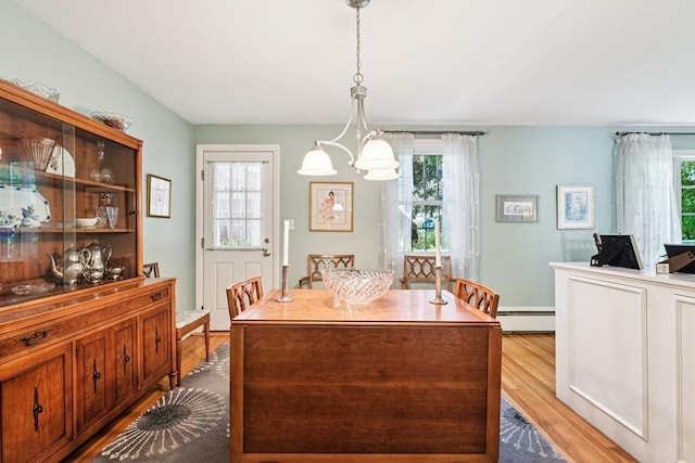 56 Conrad Rd, Melrose, MA 02176 - dining room featuring a baseboard radiator, wood finished floors, and a chandelier