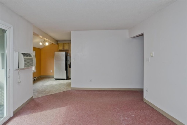 11 Arbor Way Unit C, Holyoke, MA 01040 - spare room with light colored carpet, an AC wall unit, and baseboard heating